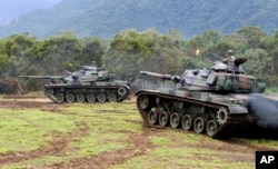 FILE - Tanks are seen during military exercises in Hualien, eastern Taiwan, Jan. 30, 2018.