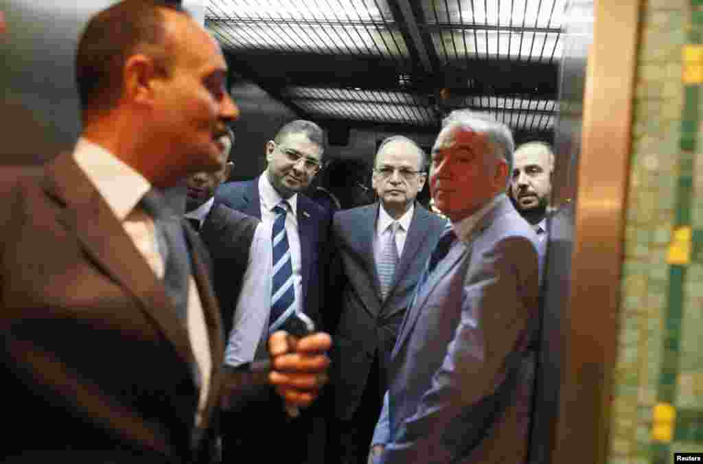 Syrian Coalition Secretary General Nasr al-Hariri, right and Chief Syrian Opposition Coalition negotiator Hadi al-Bahra, second from right, arrive at the Arab League's headquarters in Cairo to meet with the league's Secretary General Nabil al-Araby, Sept. 8, 2014.