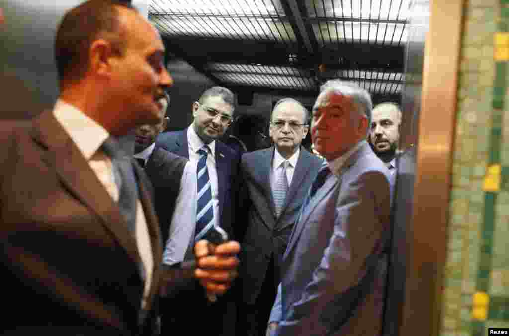 Syrian Coalition Secretary General Nasr al-Hariri, right and Chief Syrian Opposition Coalition negotiator Hadi al-Bahra, second from right, arrive at the Arab League&#39;s headquarters in Cairo to meet with the league&#39;s Secretary General Nabil al-Araby, Sept. 8, 2014.