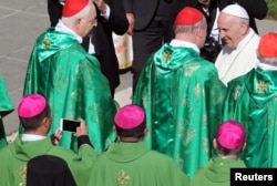 Chinese Bishop Joseph Guo Jincai takes a picture of Pope Francis after a Mass for the opening of a synodal meeting in Saint Peter's Square, at the Vatican, Oct. 3, 2018.