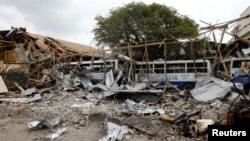 A view shows the damaged structures and school buses at the scene after a car exploded in a suicide attack near Mucassar primary and secondary school in Hodan district of Mogadishu, Somalia, Nov. 25, 2021.