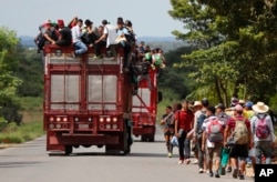 Central American migrants, part of one of the caravans hoping to reach the U.S. border, get a ride on a truck, in Isla, Veracruz state, Mexico, Nov. 3, 2018.