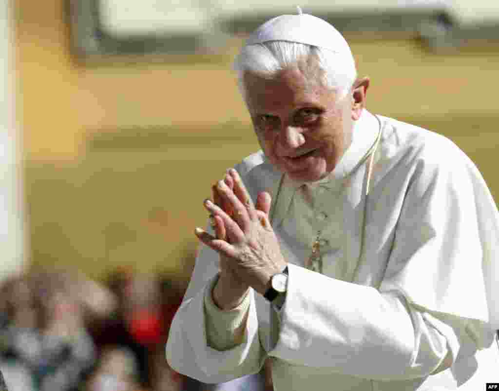 Pope Benedict XVI acknowledges faithful as he is driven through the crowd in St. Peter's Square during his weekly general audience, at the Vatican, Wednesday, Sept. 29, 2010. Benedict XVI is praying for the victims of floods in northern Nigeria that have