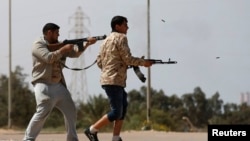 FILE - Fighters from Misrata fire weapons at Islamic State militants near the coastal city of Sirte, Libya, March 15, 2015. 