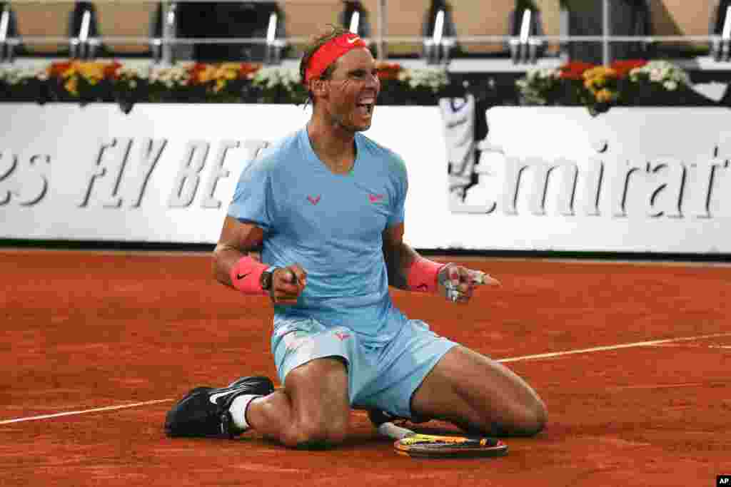 Spain&#39;s Rafael Nadal celebrates winning the final match of the French Open tennis tournament against Serbia&#39;s Novak Djokovic in three sets, 6-0, 6-2, 7-5, at the Roland Garros stadium in Paris, France.