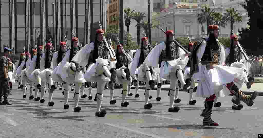 Presidential guards parade during the weekly change of guards at the Tomb of the Unknown Soldier in front of the Greek Parliament in Athens.