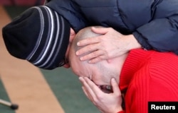 A man cries while he prays at the Quebec Islamic Cultural Centre in Quebec City, Feb. 1, 2017.