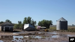 Farm buildings in Johnstown, Colorado, are damaged following this past week's floods, Sept. 17, 2013.