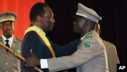 Mali's Interim President Dioncounda Traore, left, was congratulated by coup leader Amadou Sanogo after being first sworn in at a ceremony in Bamako, Mali, April 12, 2012. 