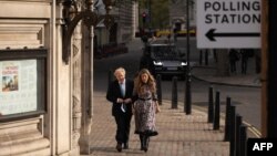 Le Premier ministre britannique Boris Johnson et sa partenaire Carrie Symonds arrivent à Methodist Hall dans le centre de Londres pour voter aux élections locales du 6 mai 2021.