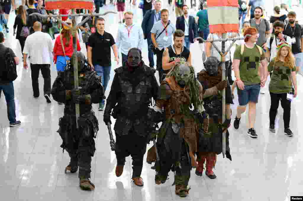 People dressed up as Middle-earth: Shadow of War game characters are seen during the world&#39;s largest computer games fair Gamescom in Cologne, Germany.