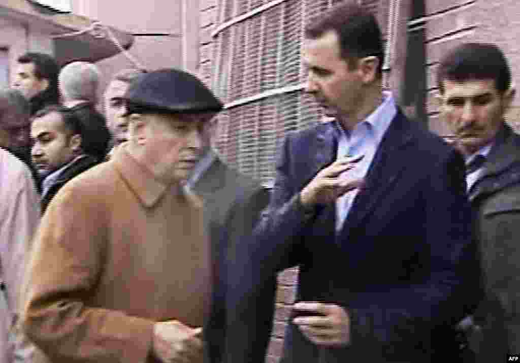 This image made from a video shows Syrian President Bashar al-Assad visiting Baba Amr, Homs, Syria, March 27, 2012. (AP, Syrian State Television)