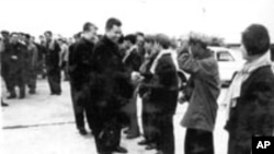 In this undated photo provided by Documentation Center of Cambodia, the late Khmer Rouge leader Pol Pot, center, greets Khmer Rouge cadre in Phnom Penh airport, Cambodia. 