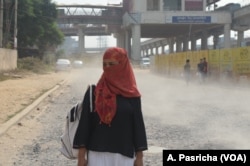 A woman on her way to work protects herself from hot winds in Gurgaon near New Delhi, India.