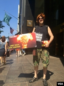 Paul Rosen regularly demonstrates outside Trump Tower. He considers Clinton a war criminal for voting to invade Iraq, but still sees her as the better option against Trump. (R. Taylor/VOA)