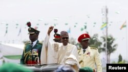 Nigeria's new President Muhammadu Buhari rides on the motorcade while inspecting the guard of honor at Eagle Square in Abuja, Nigeria, May 29, 2015. 