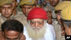 Asaram Bapu, a controversial spiritual guru who was arrested on Sept.1 on a rape charge filed by a teenage girl is brought to a hospital for a medical check up in Jodhpur, India, Sept. 9, 2013.