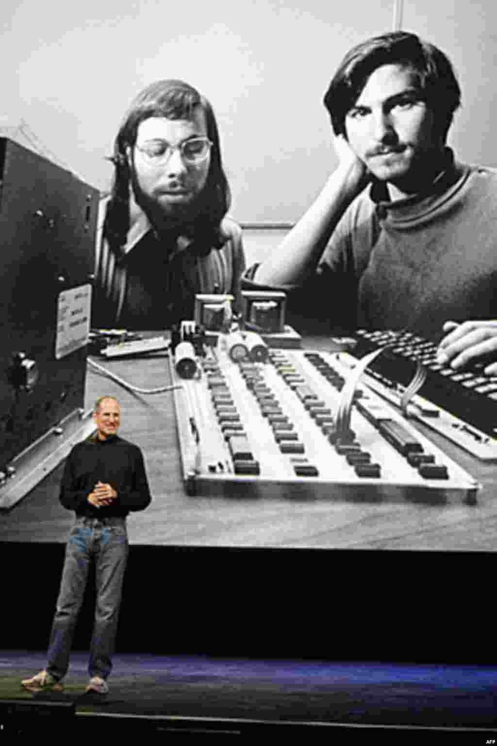 In this file photo taken January 27, 2010, Steve Jobs stands in front of a photo of himself, right, and Steve Wozniak, left, during an Apple event in San Francisco. (AP)