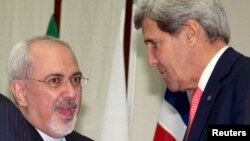 U.S. Secretary of State John Kerry (R) shakes hands with Iranian Foreign Minister Mohammad Javad Zarif at the United Nations Palais in Geneva, Nov. 24, 2013. 