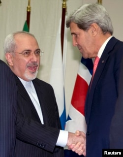 U.S. Secretary of State John Kerry (R) shakes hands with Iranian Foreign Minister Mohammad Javad Zarif at the United Nations Palais in Geneva, Nov. 24, 2013.