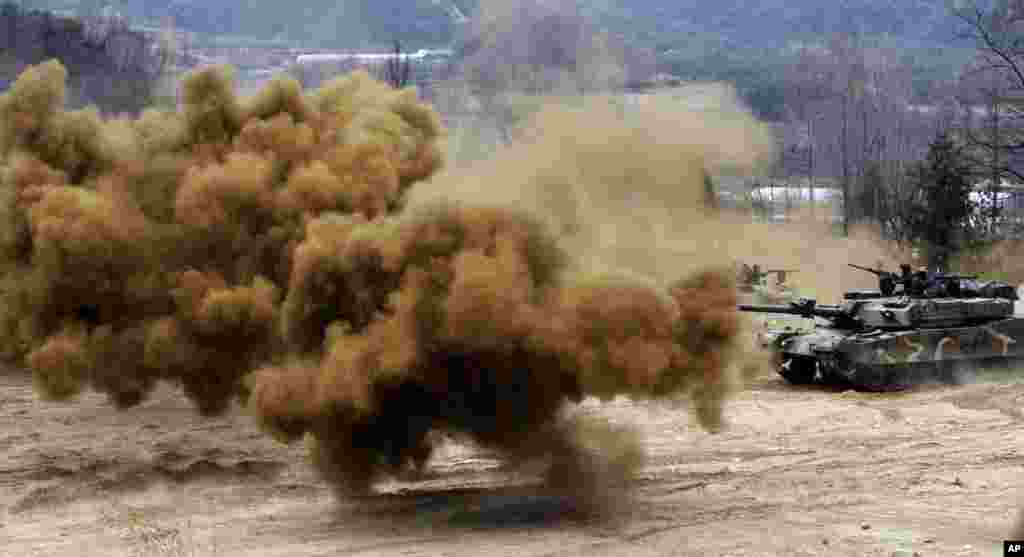 Smoke bombs explode near South Korean army tanks during an exercise against possible attacks by North Korea near the demilitarized zone (DMZ) in Hwacheon, South Korea. 