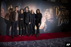 Actors from left, Luke Evans, Emma Watson, Dan Stevens, Stanley Tucci and Audra McDonald pose for photographers during a photo call for the Beauty And The Beast Premiere, in London, Feb. 24, 2017.