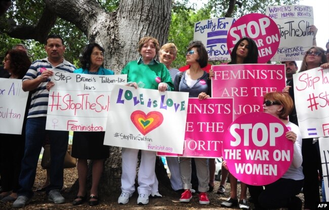 FILE - Supporters of Women's Rights and LGBT groups protest across from the Beverly Hills Hotel, owned by the Sultan of Brunei, demanding he rescind a Taliban-like Brunei penal code which included the stoning to death of gay men and lesbians.