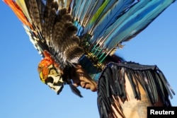 FILE - A reveller gets ready to dance during a "pow-wow" celebrating the Indigenous Peoples Day Festival in Randalls Island, New York, October 11, 2015.