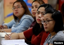 Filipino workers, including nurses applying to work in United Kingdom, attend a lecture at a review center for the International English Language Testing System or IELTS in Manila, Philippines, April 2, 2019.