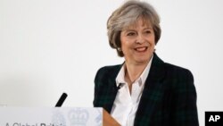 Britain's Prime Minister Theresa May smiles after she delivers a speech on leaving the European Union at Lancaster House in London, Jan. 17, 2017.