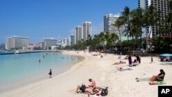 People relax on the beach in Waikiki in Honolulu, March 13, 2017. As Hawaii begins to prepare for the possibility of a North Korean missile strike, the emergency management agency reiterates, "Hawaii is still safe."