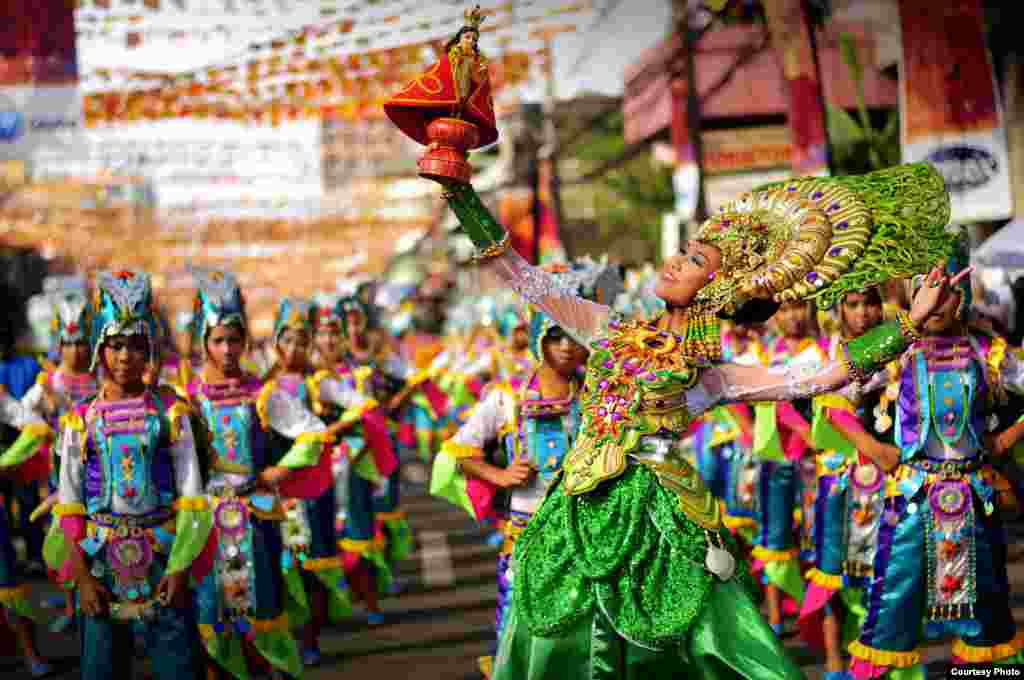 Participants in bright colored costumes dance in a parade in Cebu City, Philippines, to celebrate the Sinulog, an annual festival commemorating the Filipino people&#39;s pagan origin, and their acceptance of Roman Catholicism. The festival is held on the third Sunday of January. (Photo submitted by Froilan G. Rogor Jr. to 2013 VOA Photo Contest)