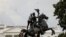 FILE - Protesters attach a chain to the statue of President Andrew Jackson to pull down in the middle of Lafayette Park outside the White House as someone throws a roll of toilet paper during racial inequality protests in Washington, D.C., June 22, 2020.