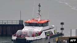 FILE - UK Border Force Cutter 'Typhoon' carrying migrants, some of the first in 2024 to be picked up at sea attempting to cross the English Channel from France, as returns to the Marina in Dover southeast England, on January 13, 2024.