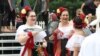 Dancers with Baltimore's "Bailes de Mi Tierra" Mexican folk dance group chat before their performance at the One Journey Festival in support of refugees, Washington, June 2, 2018. (V. Macchi/VOA)