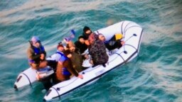 FILE: This image provided by the Marine Nationale (French Navy) shows migrants aboard a rubber boat after being intercepted by French authorities, off the port of Calais, northern France, Tuesday, 12.25.2018