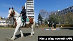 Manuela Jimenez, 15, rides Splash in a riding lesson at Ebony Horse Club in Brixton, south London, Sunday, April 18, 2021. (AP Photo/Kirsty Wigglesworth)