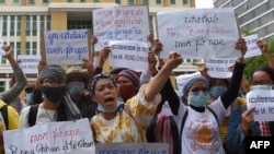 FILE - Supporters of Rong Chhun, the arrested leader of the Cambodian Confederation of Unions, protest in front of Phnom Penh municipal court, Aug. 1, 2020. 