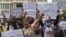 FILE - Supporters of Rong Chhun, the arrested leader of the Cambodian Confederation of Unions, protest in front of Phnom Penh municipal court, Aug. 1, 2020. 