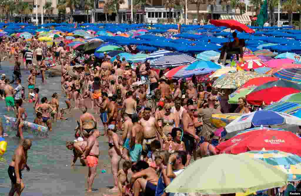 People cool off at the beach during the heatwave in the southeastern coastal town of Benidorm, Spain.