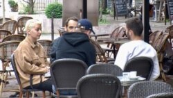Young people having coffee in Paris. France reopened bars and restaurants mid-may as coronavirus cases dropped. (Lisa Bryant/VOA)