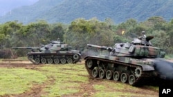 FILE - Tanks are seen during military exercises in Hualien, eastern Taiwan, Jan. 30, 2018.