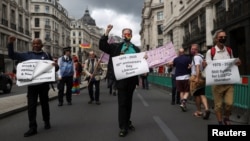 Veteran British LGBT+ rights campaigner Peter Tatchell takes part in the Gay Liberation Front pride march in London, June 27, 2020. 