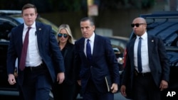 Hunter Biden, center, and his wife Melissa Cohen Biden, arrive at federal court for jury selection for his trial on felony tax charges, Sept. 5, 2024, in Los Angeles.