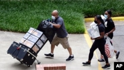 College students with the assistance of family begin moving in for the fall semester at N.C. State University in Raleigh, N.C., July 31, 2020.