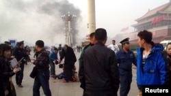 Smoke rises near the main entrance of the Forbidden City at Tiananmen Square in Beijing Oct. 28, 2013,after a car plowed into pedestrians and caught fire, killing five.