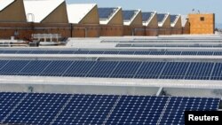 FILE - Solar panels sit on the roof of SunPower Corp. in Richmond, Calif., March 18, 2010.