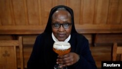 Benedictine Sister Gertrude drinks a "Maredret" beer in Anhee, Belgium, Dec. 8, 2021.