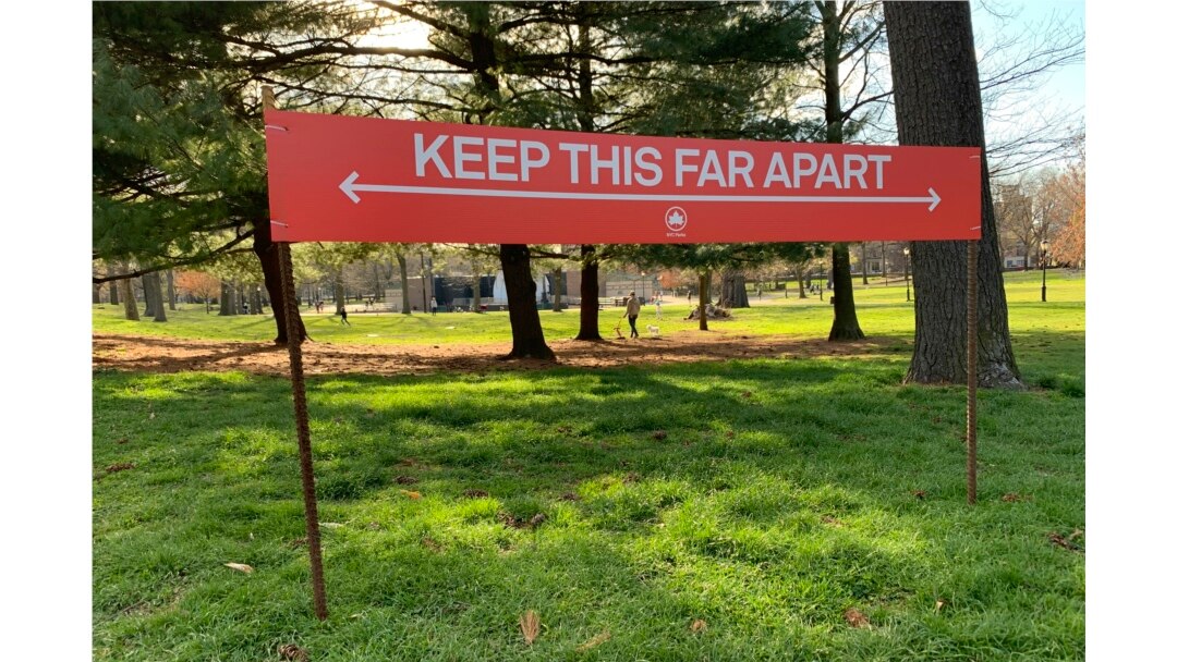 Signage urging social distancing is seen in Prospect Park in the Brooklyn borough of New York, April 8, 2020.