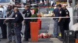 Mideast Israel Palestinians Israeli policemen stand by the body of a Palestinian at the scene of an stabbing attack in Jerusalem Saturday, Oct. 10, 2015